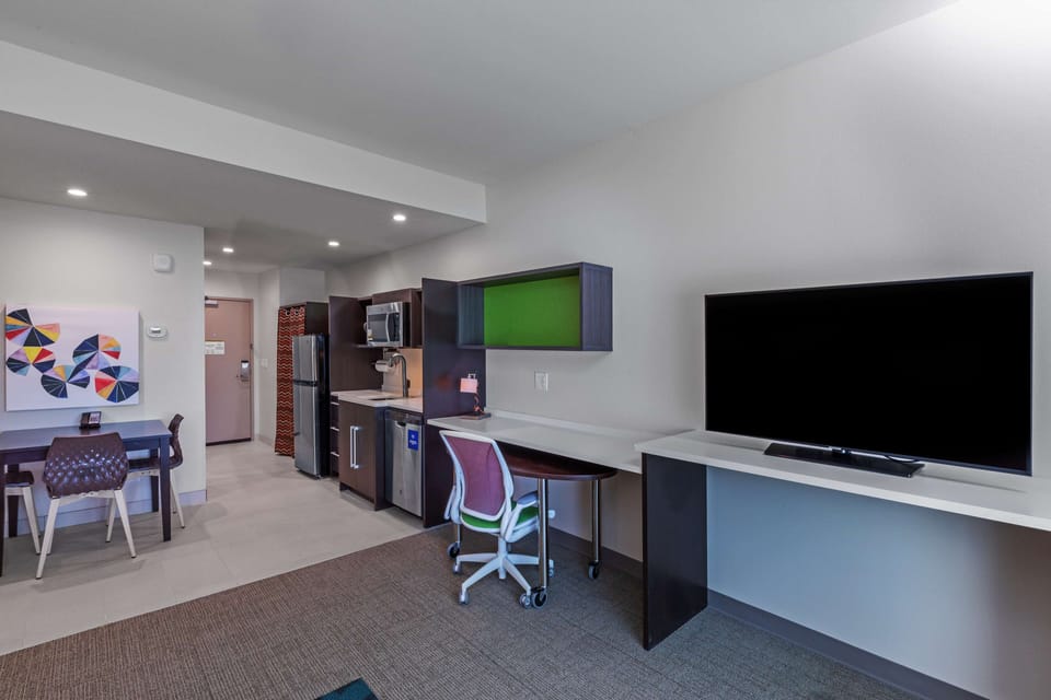 Premium bedding, desk, laptop workspace, blackout drapes