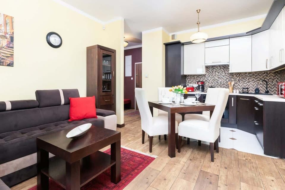 Another angle of the same living room with a comfortable sofa, coffee table, and a TV stand in a bright and open space.