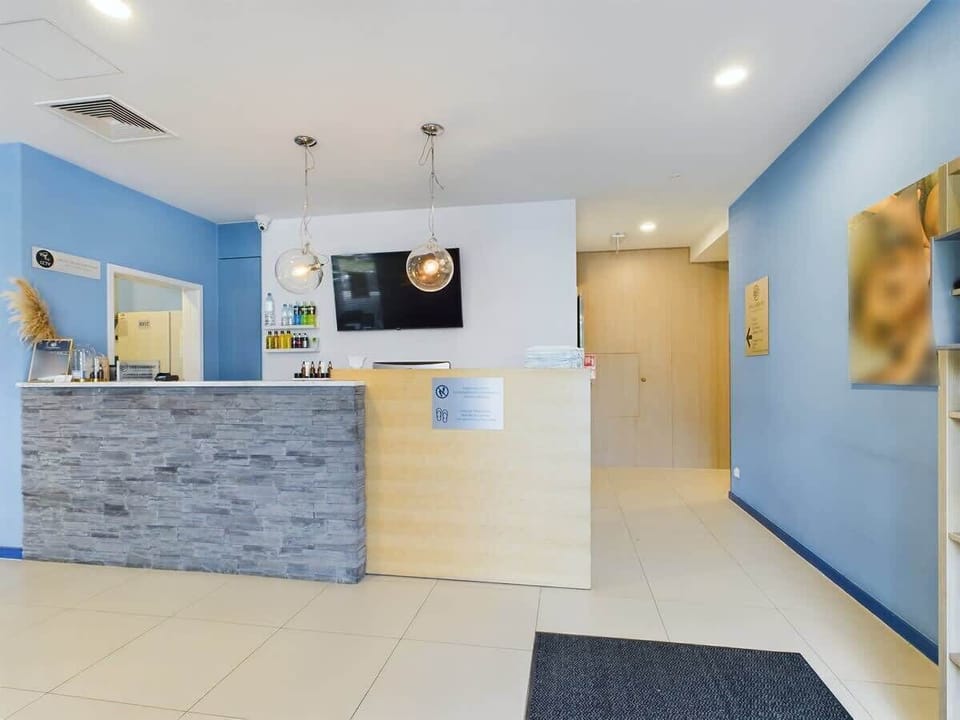 Another angle of the reception space, showcasing minimalist decor, sleek design, and ample natural lighting for a professional yet inviting vibe.