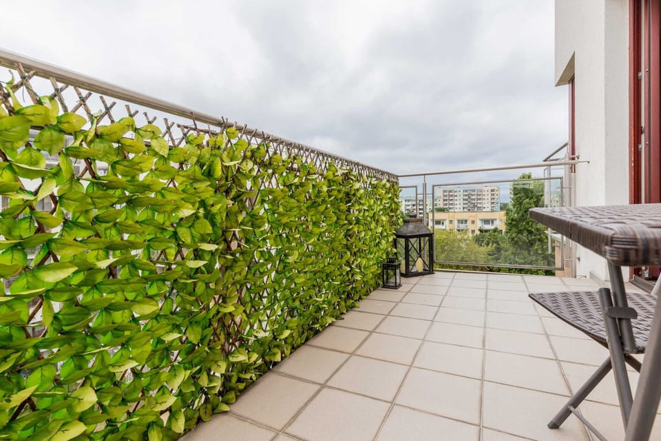 Cozy balcony corner decorated with greenery.
