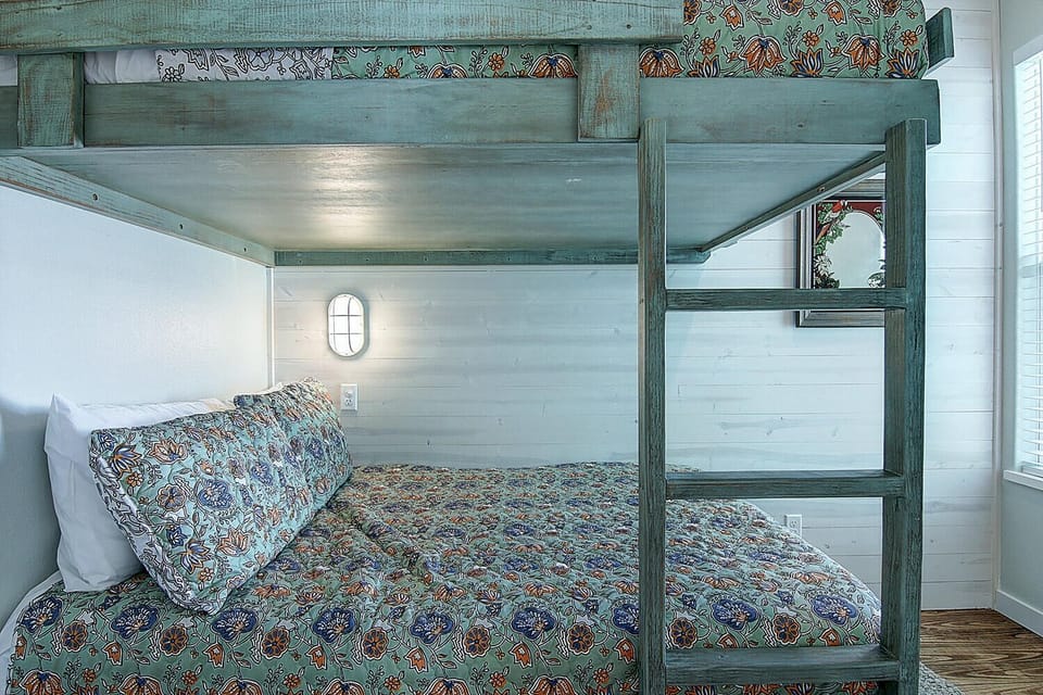 Rest peacefully in your cozy bunk beds with charming patterned linens, perfect for families or friends sharing sweet dreams.