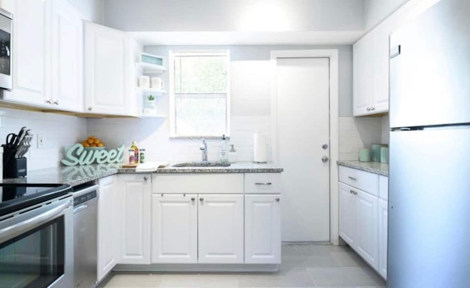 Full functioning kitchen stocked with all necessary cooking utensils .