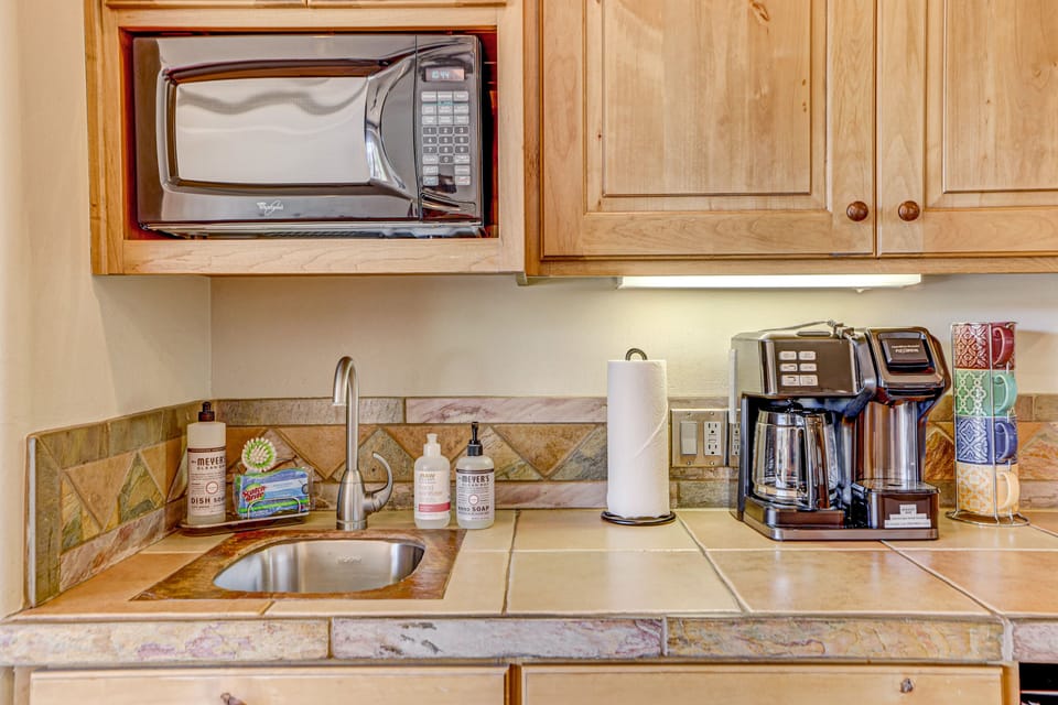 Kitchenette with many essentials. Full-size coffee pot with addtl Keurig style.
