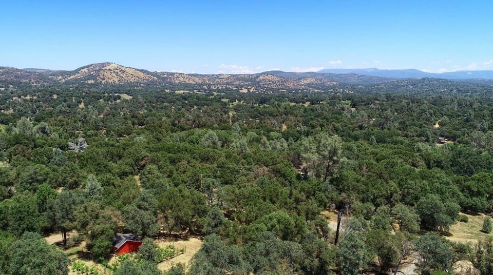 arial view looking down at our barn and the Sierra Nevada mountain range