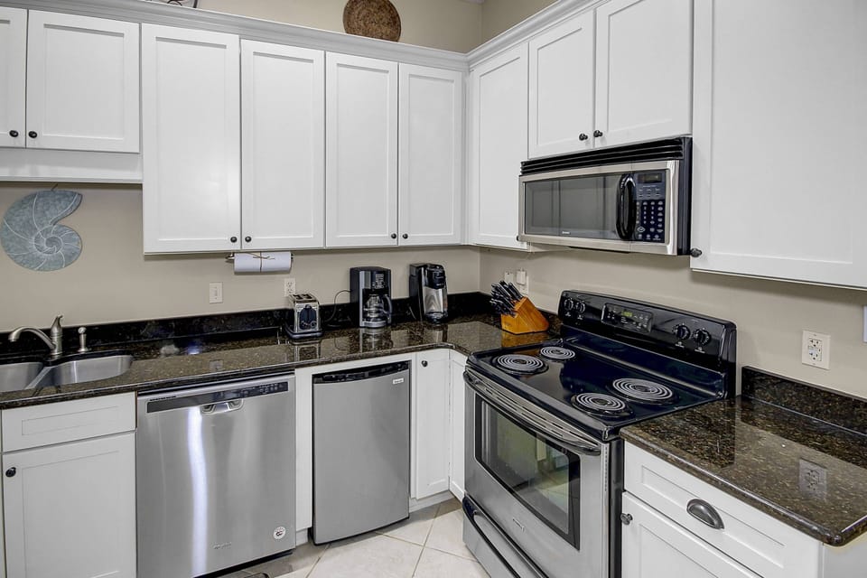 Open kitchen area with stainless steel appliances