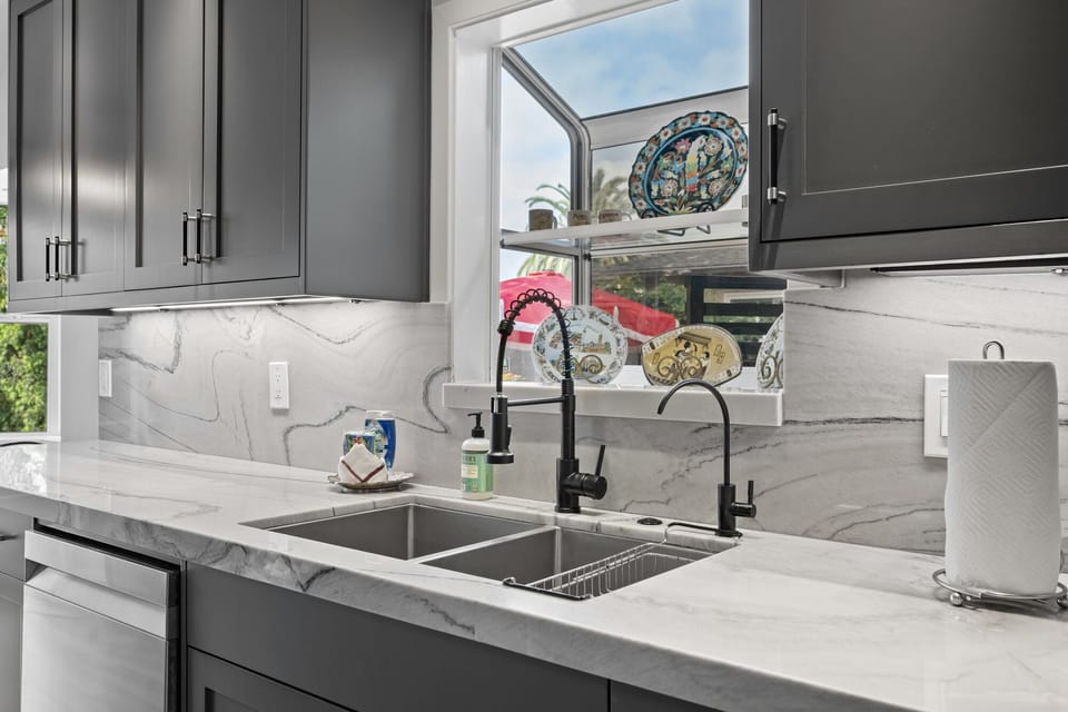 Kitchen includes stainless steel sink with modern fixtures.