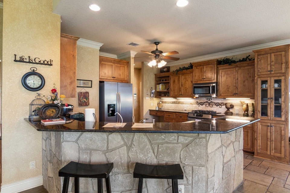 Additional bar-style seating faces the Retreat's enormous and fully-appointed kitchen.