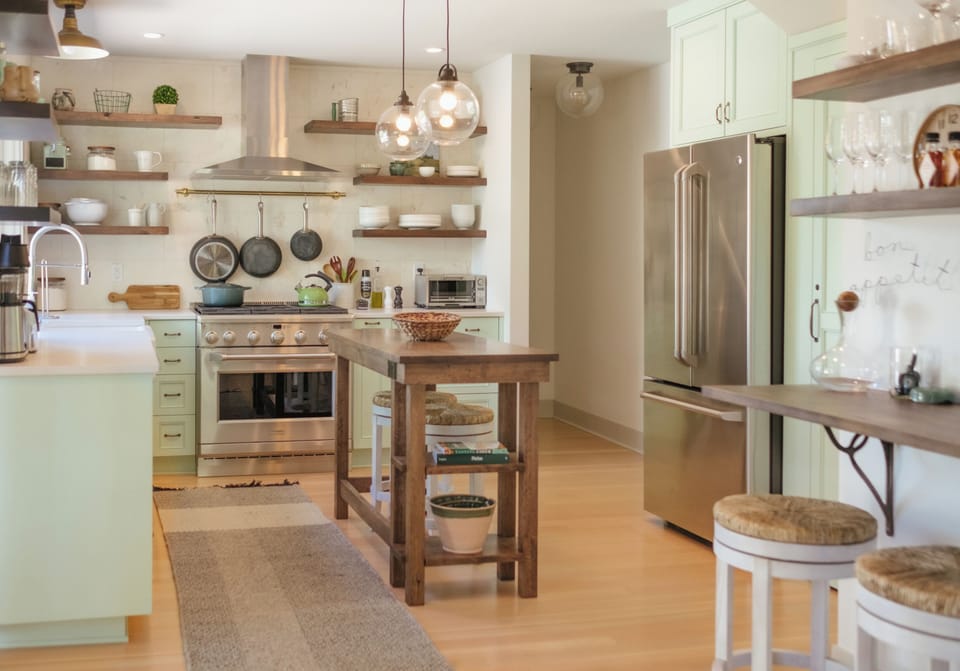 Kitchen has a custom island for prep, with seating