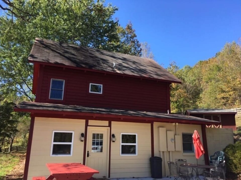 Front patio has picnic table and patio table with chairs.
