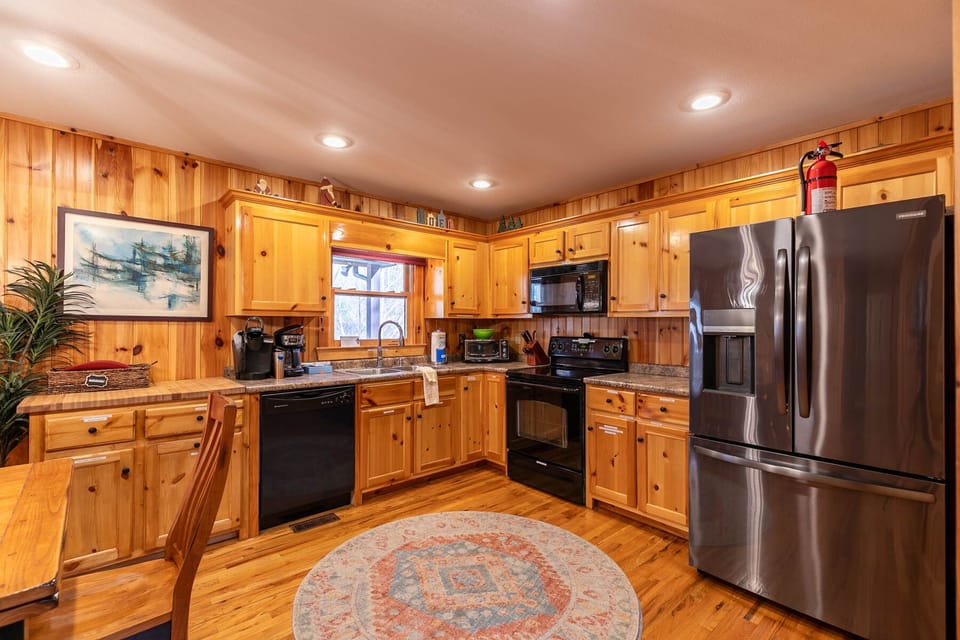 A warm, fully equipped kitchen at Riverbend Retreat, ready for everything from morning coffee to big group dinners.