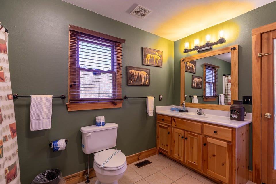 Rustic charm meets mountain character at Riverbend Retreat, with warm pine cabinetry and cozy wildlife accents throughout.