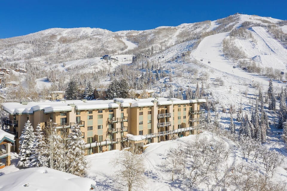 Winter wonderland surrounds this mountain resort with pristine ski slopes and snow-covered peaks creating a stunning alpine backdrop.