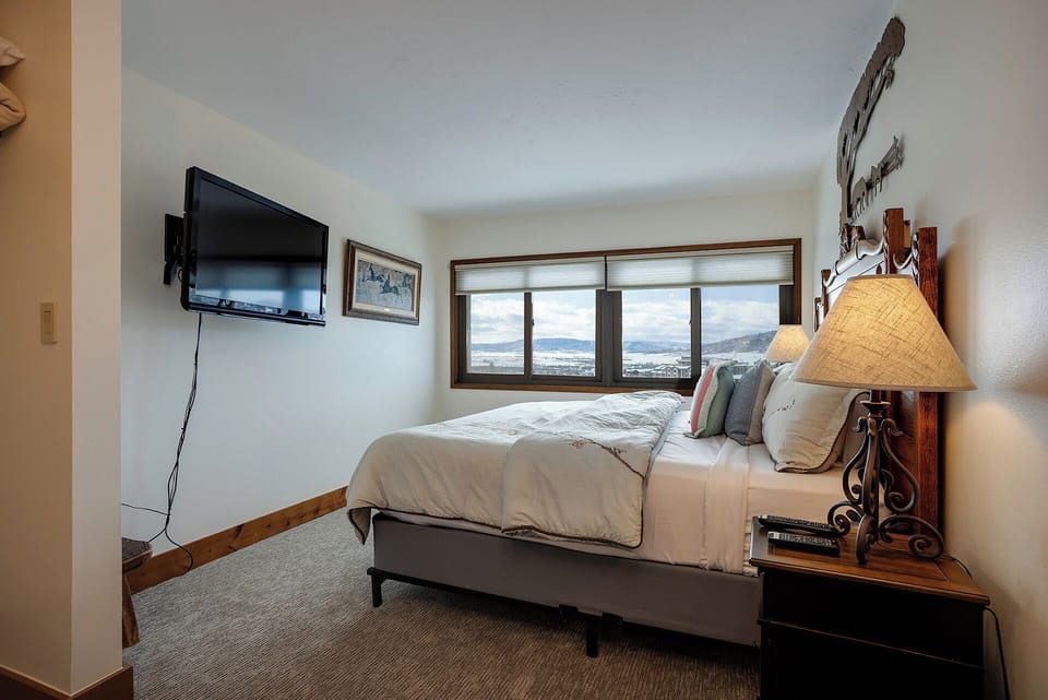 Wake up to stunning mountain vistas from your cozy bedroom, complete with modern amenities and rustic charm for ultimate relaxation.