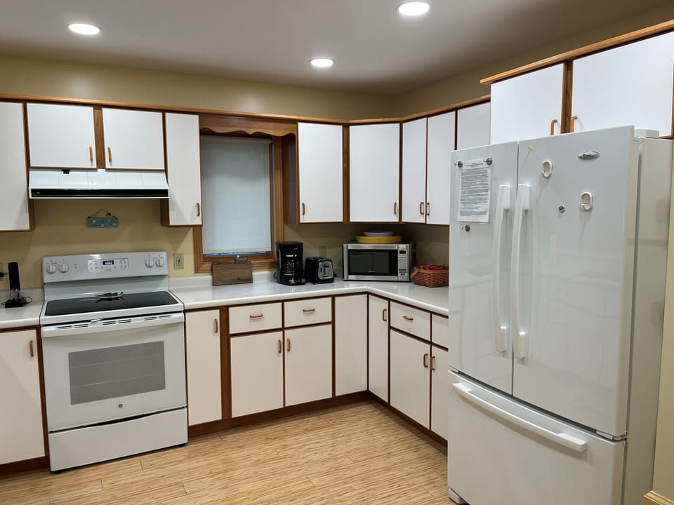 Kitchen - large refrigerator, oven/stove, microwave, and dishwasher