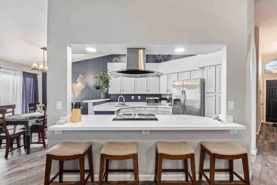 This modern kitchen features a Cortez countertop island that flows seamlessly into the living room, offering a perfect spot for gathering, dining, or entertaining