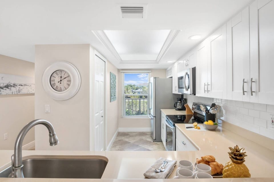 The fully equipped kitchen has been updated with modern finishes like quartz countertops and stainless steel appliances.