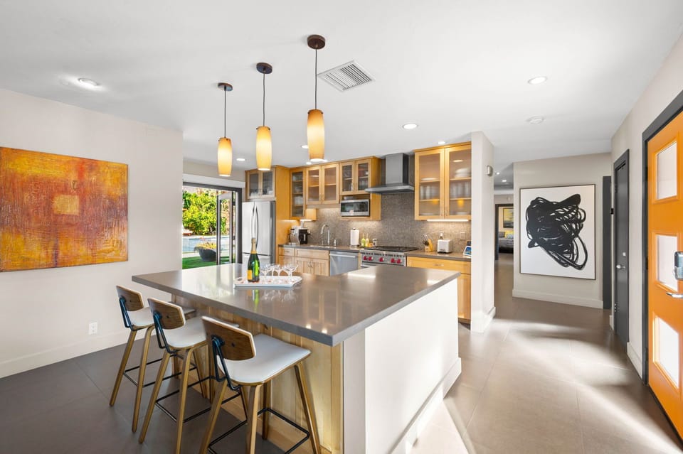 Step into your stylish kitchen where warm pendant lights illuminate the spacious island, perfect for morning coffee or evening wine.