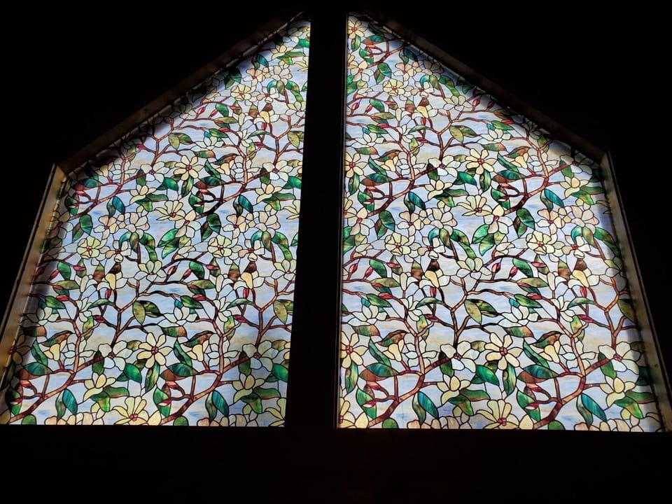 Stained glass cathedral windows and vaulted ceiling.
