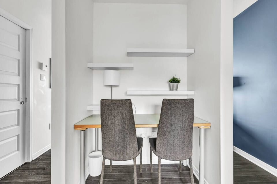 Dedicated workspace with desk, chairs, shelves, and good lighting—ideal for remote work
