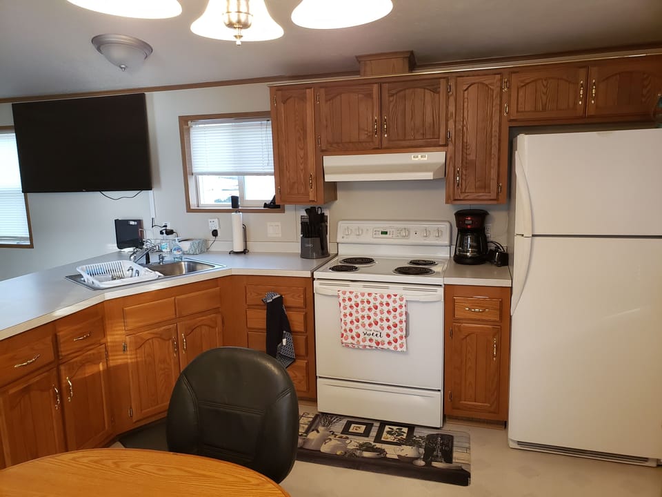 Kitchen  - Electric Stove and Oven, Microwave and Refrigerator (No Ice Maker)