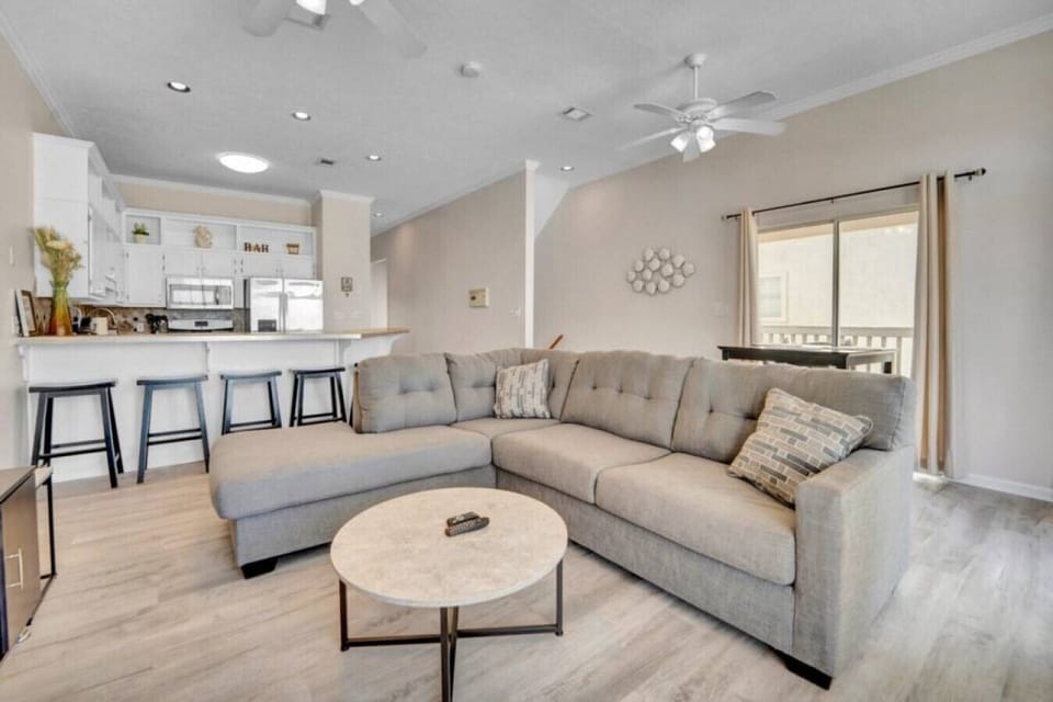 Gather, relax, and unwind in this open living space with bar seating and cozy vibes.