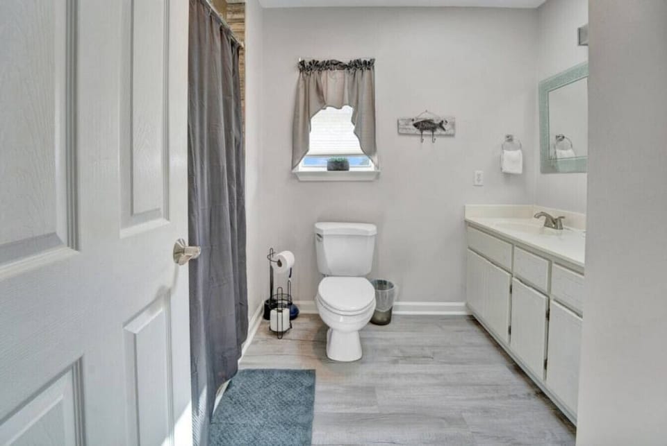 Full bathroom with shower/tub combo—bright, clean, and ready for post-beach refreshes.