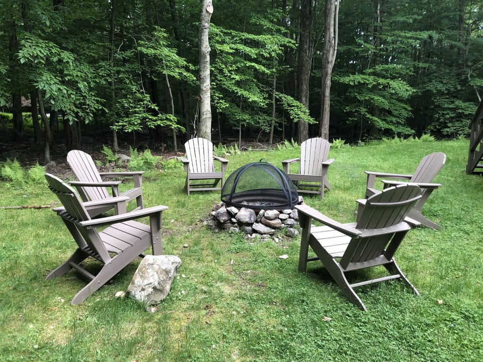 Fire Pit in the Yard with 6 Comfortable Adirondack Chairs 