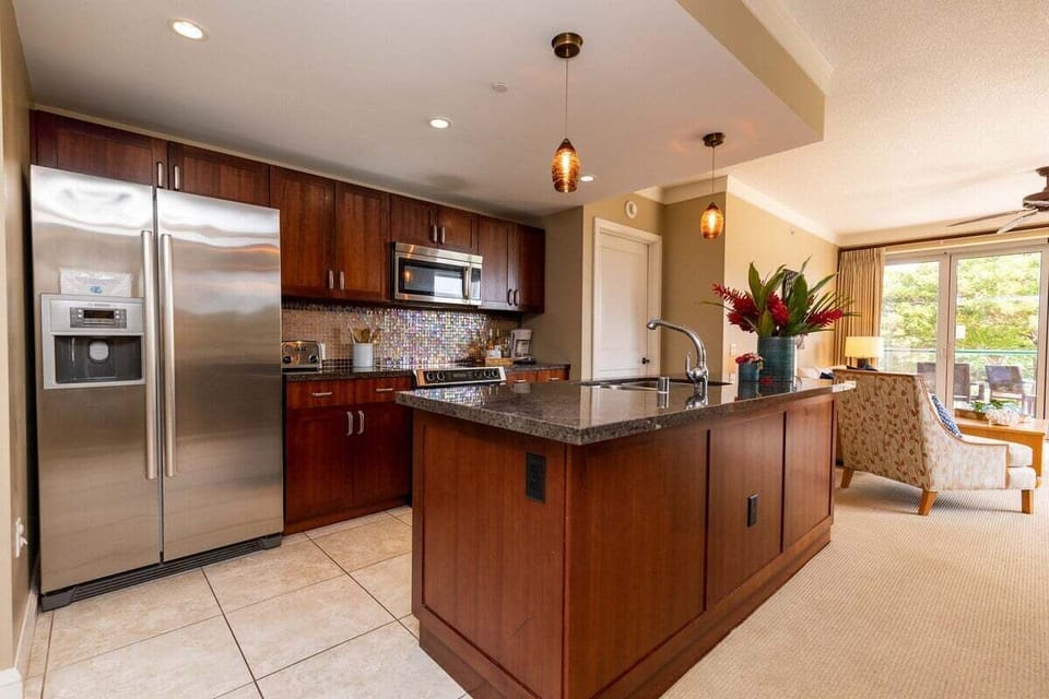 Prepare meals in a sleek kitchen featuring stainless steel appliances and a large island