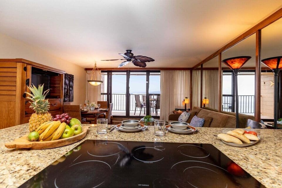 Enjoy preparing meals while overlooking the cozy living room and balcony with ocean views
