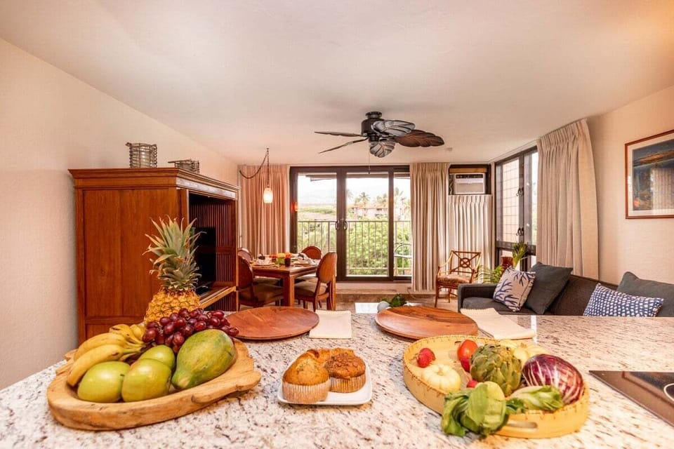 Inviting kitchen island with polished granite surfaces and a view into the airy living space for seamless entertaining