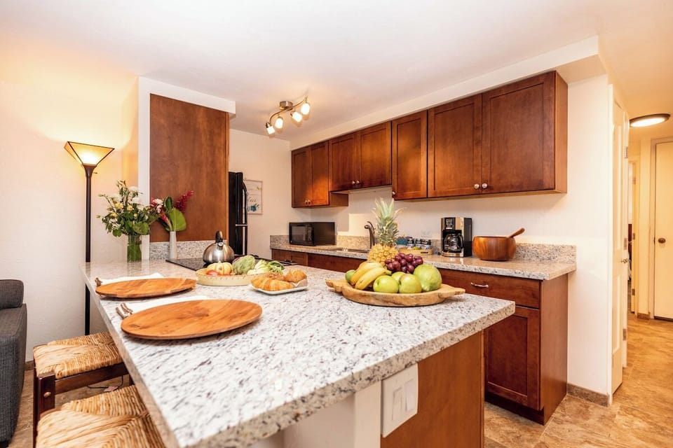 Fully equipped kitchen showcasing elegant granite surfaces and natural textures for a stylish cooking experience.