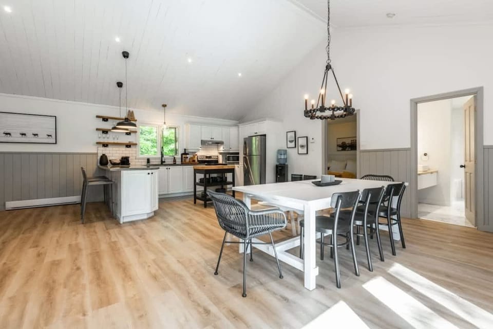 Spacious dining area with high ceilings—creating an open, airy atmosphere perfect for gatherings and meals.