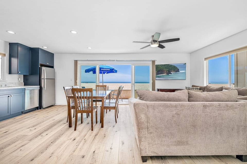 Bright open-concept living space with ocean views throughout
                