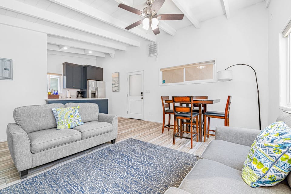 Open-concept living and dining area with comfortable seating and abundant natural light.
                