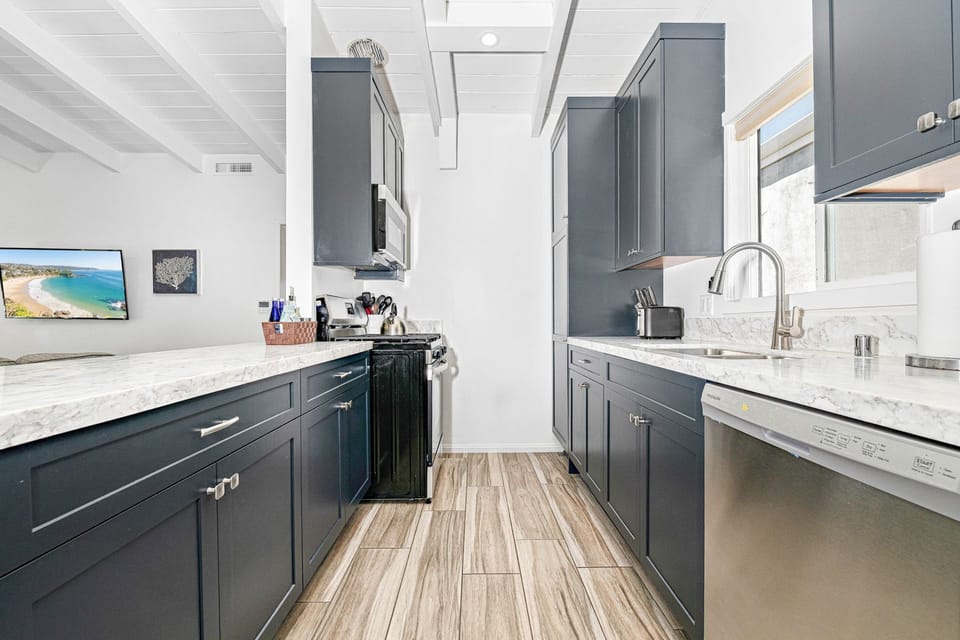 Bright and stylish kitchen with ample counter space and updated finishes.
                