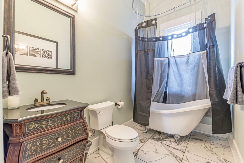 Bath2: Full bath with a nod to the house's history