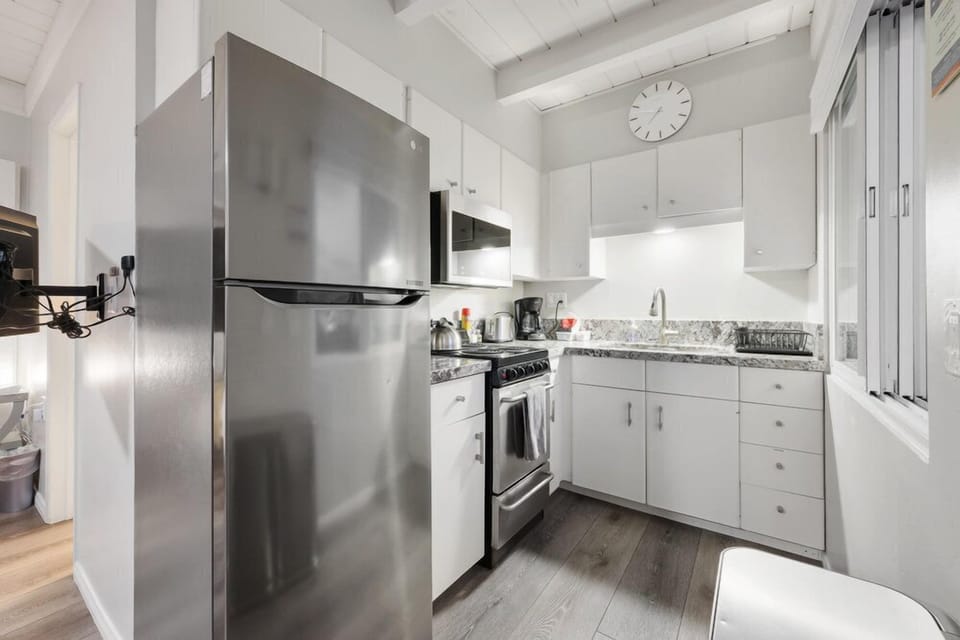 Well-equipped kitchen with stainless steel appliances and plenty of workspace.