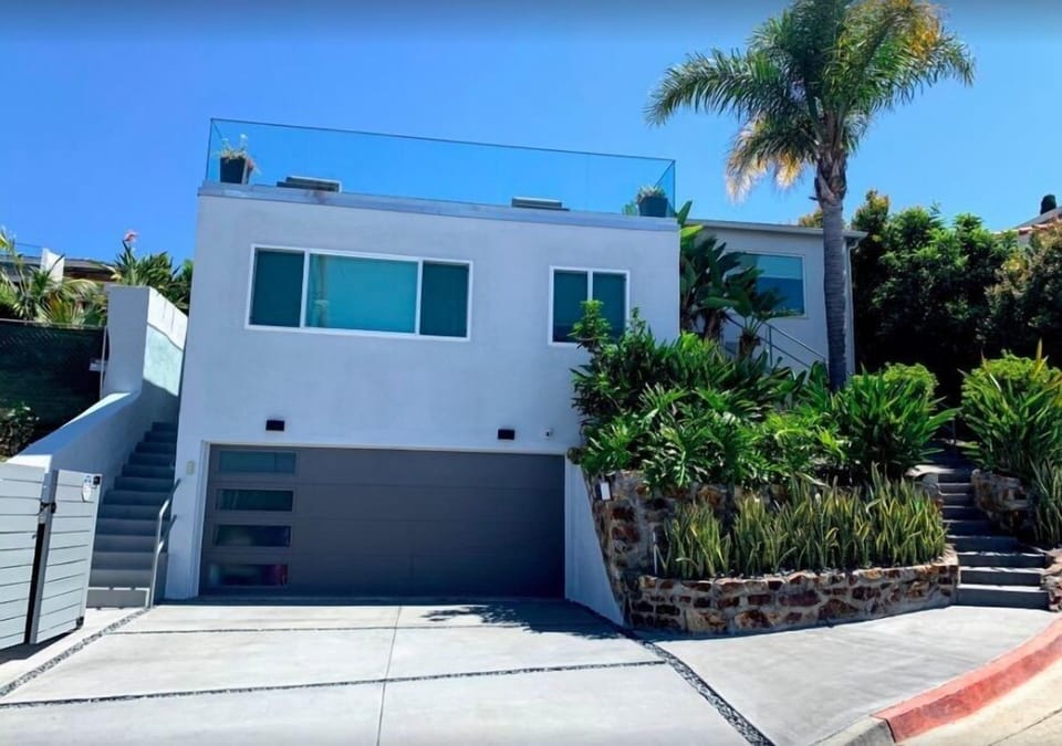 Exterior view of the property, with the studio situated above the garage.