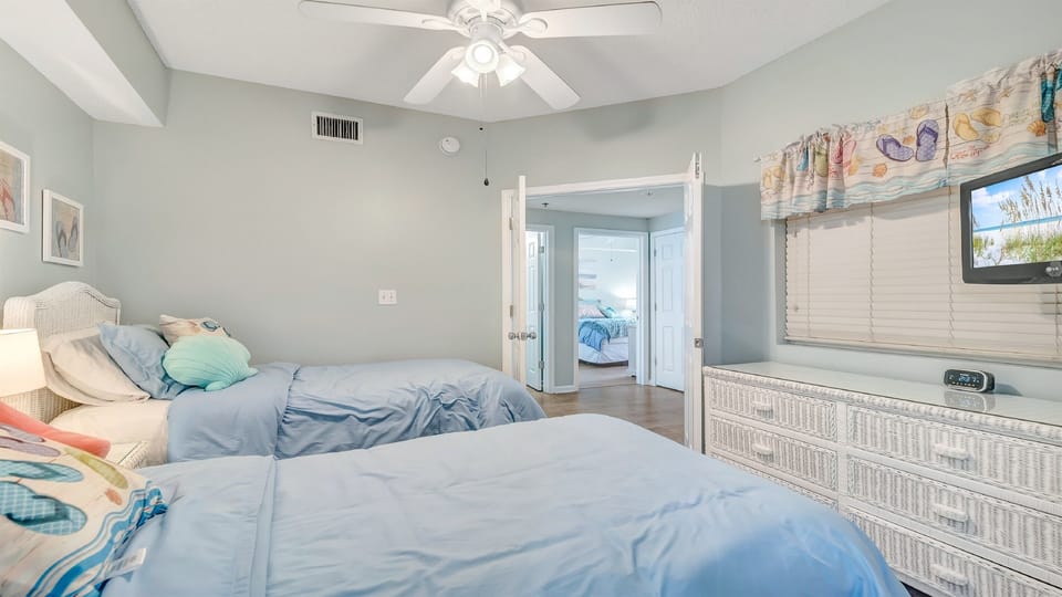 A versatile bedroom featuring two twin beds, ideal for families or friends traveling together, with a comfortable and welcoming atmosphere.