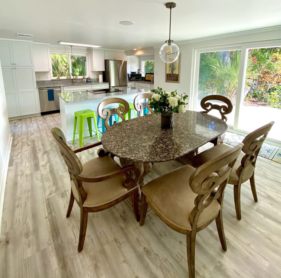 Granite dining table seats 6 (4 barstools behind)