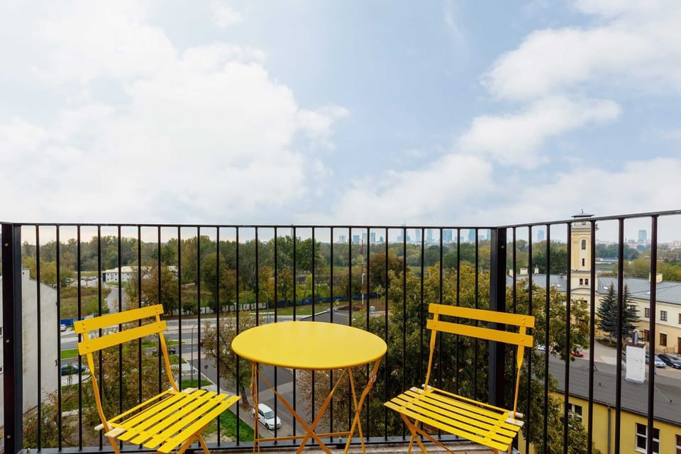 Another view of the balcony, offering a scenic outlook on the surrounding area and clear blue skies.
