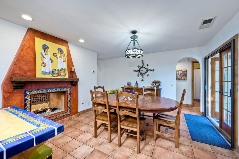 The warmth of the fireplace can be enjoyed while dining.