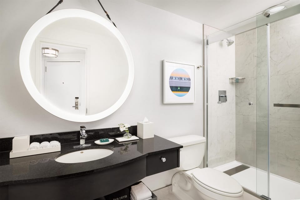 Shower, designer toiletries, hair dryer, towels