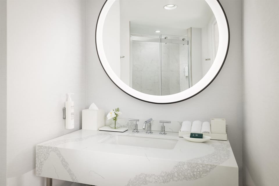 Shower, designer toiletries, hair dryer, towels