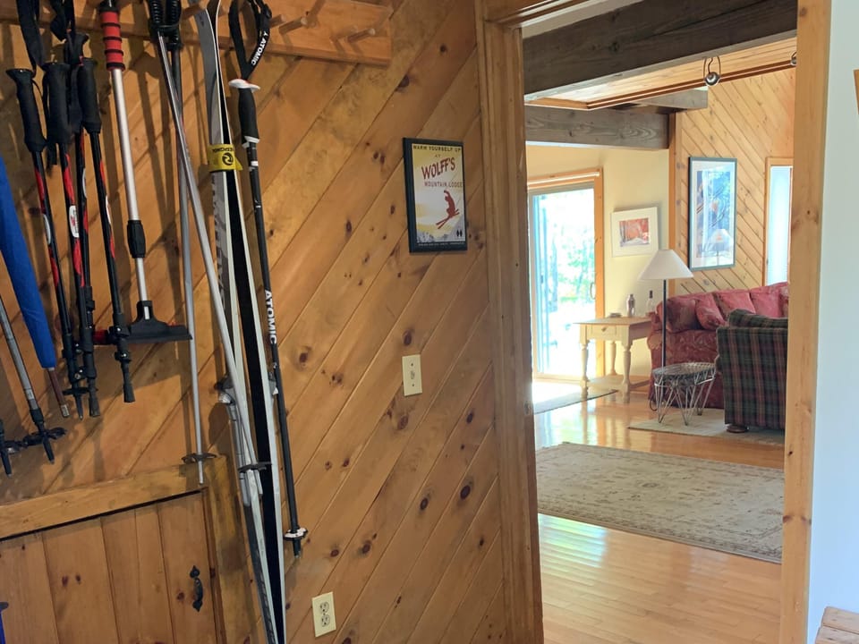 Entry mudroom with benches, coat hooks, ski racks