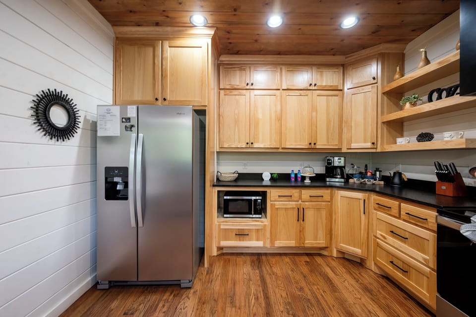 Your fully equipped kitchen features warm wood cabinetry, stainless appliances, and everything you need to whip up home-cooked meals during your stay.