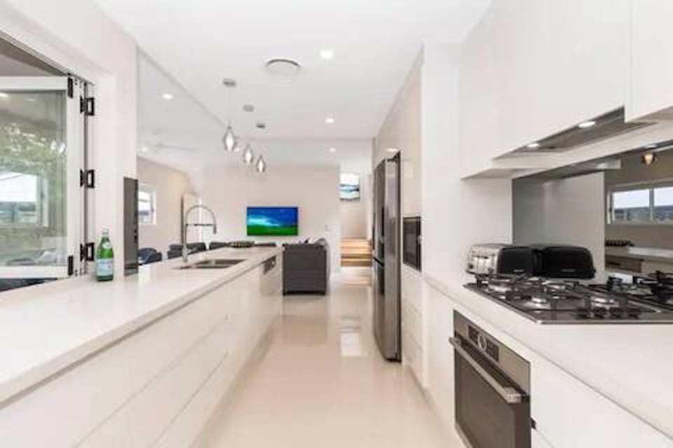 Kitchen with European appliances, breakfast bar and BBQ access.