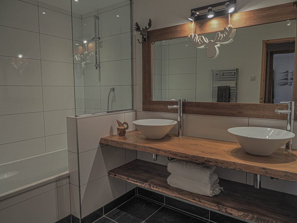 Stunning bathroom with bath and shower over, double sinks
