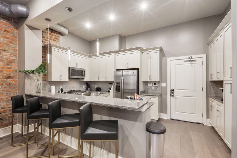 Cook and dine easily in the fully stocked kitchen, equipped with all stainless steel appliances, gas range, basic cookware, and a dining area for a comfortable meal at home. Entertain at the bar with seating for four.