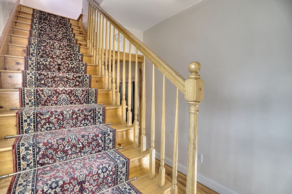 Staircase to all bedrooms and full bath upstairs